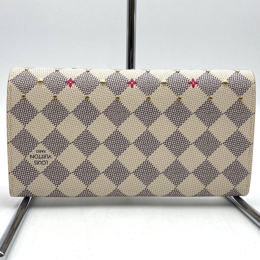 Louis Vuitton Portefeuille Sarah N45296, a cute bifold long wallet with flower studs, made of Damier Azur canvas in beige/pink.